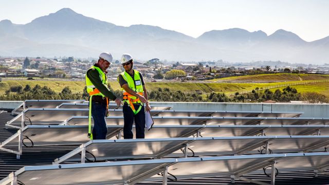 technicians inspecting solar panels on 200kWp grid-tied solar system in the Garden Route, George