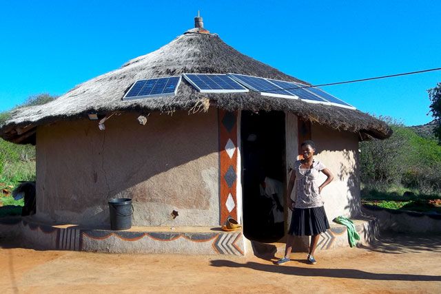 Rural smartgrid electrification rural Africa hut with solar array and resident