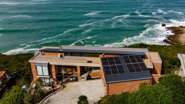 Solar PV panels with ocean backdrop at Heralds Bay, Garden Route