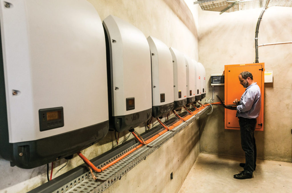 Image of an engineer setting the 200 kVA inverters used for Grid-tied solar installation in George, Garden Route South Africa