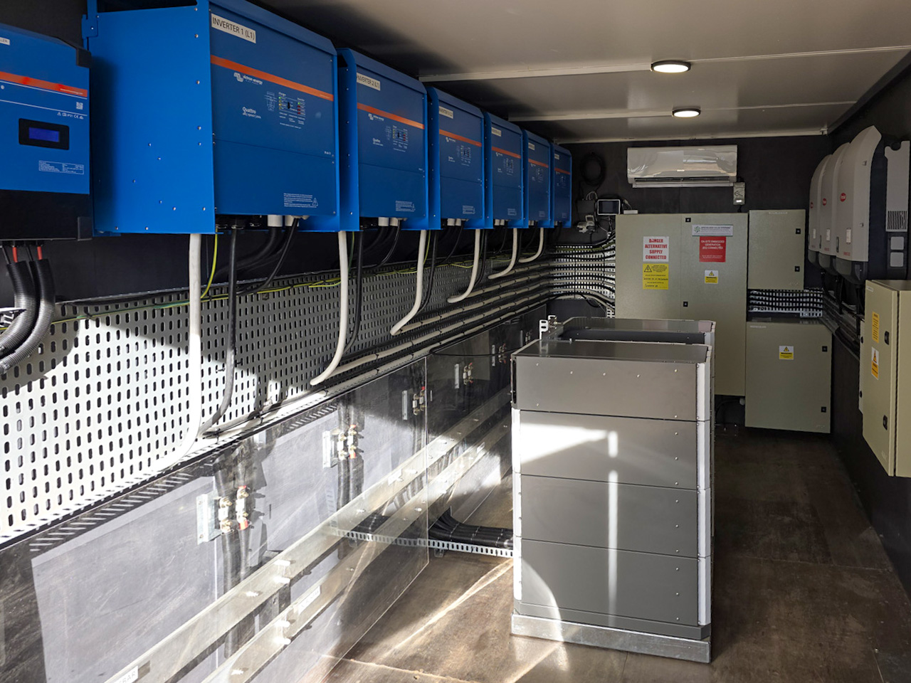 Victron inverters and battery equipment inside Riverside Lodge’s containerised solar system