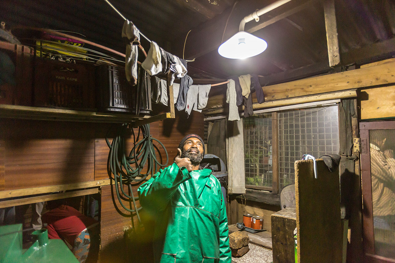 man enjoys renewable energy from solar tower distribution project in Cape Town 