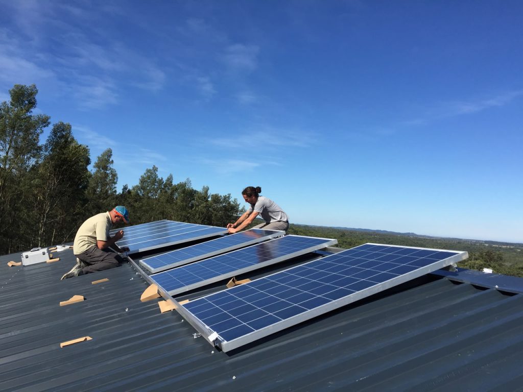 technicians on the roof installing PV