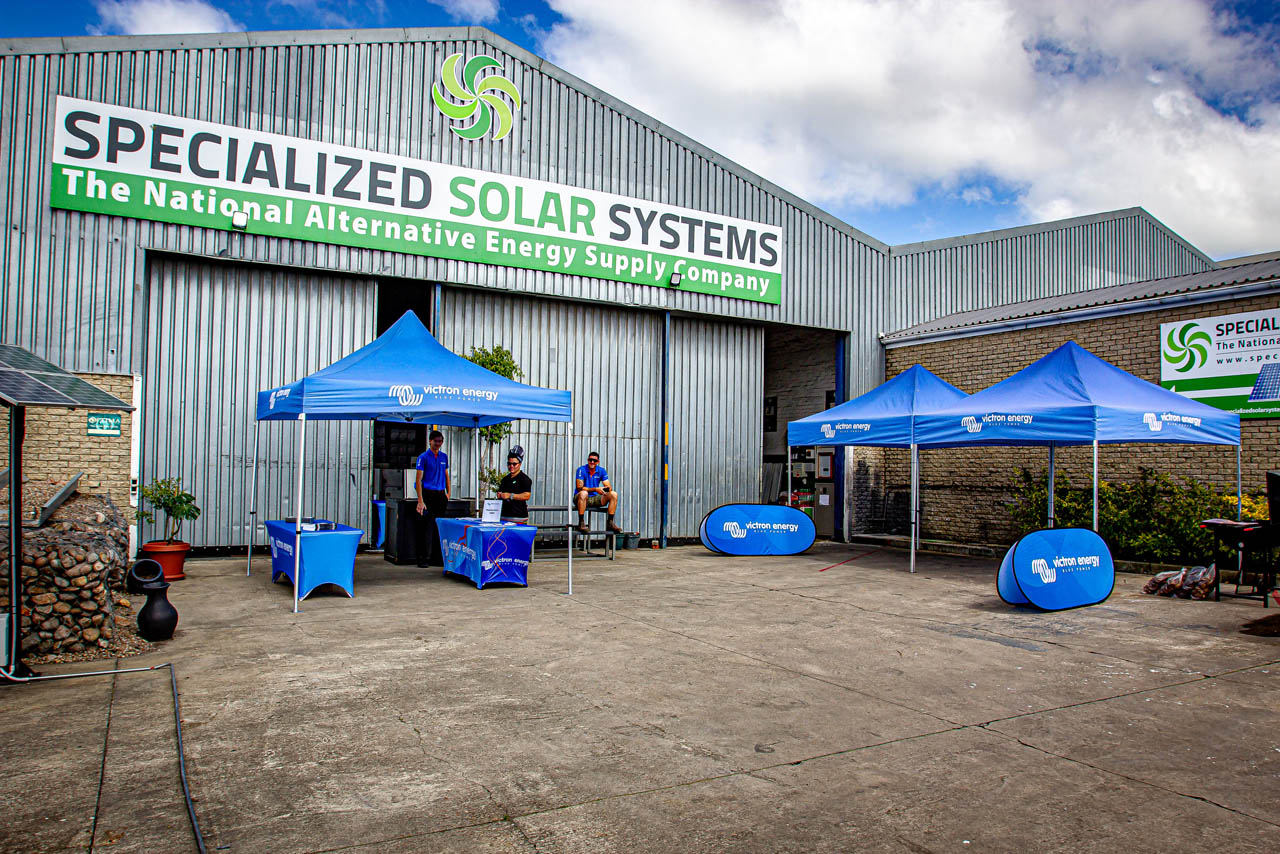Exterior training setup for attendees showing branding of Specialized Solar Systems and Victron Energy