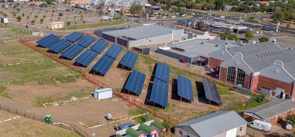 large grid-tied solar system installation aerial view of solar panel banks