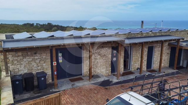 House with solar panels for an off-grid solar power system installed in Aniston
